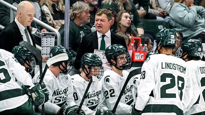 Michigan State's head coach Adam Nightingale, center, talks with the team during a break in the action in the first period of the game against New Hampshire on Thursday, Oct. 9, 2025, at Munn Ice Arena in East Lansing.