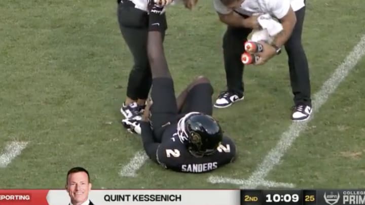 Trainers work on Shedder Sanders’s cramp. Trainers work on Shedder Sanders’s cramp.