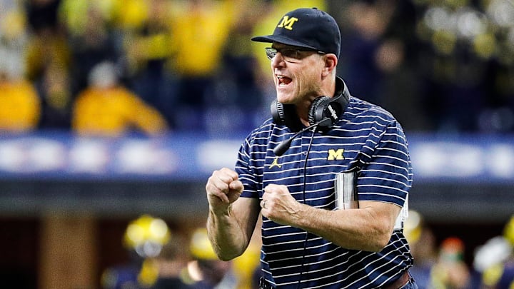 Michigan head coach Jim Harbaugh celebrates scoring a two point conversion against Purdue during the