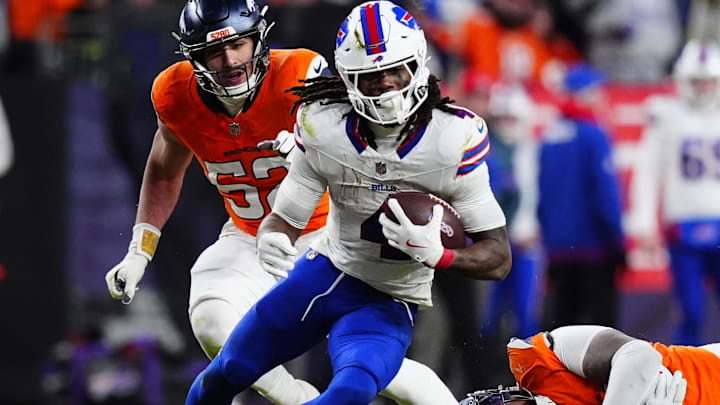 Buffalo Bills running back James Cook runs against Denver Broncos linebacker Jonah Elliss and defensive end Eyioma Uwazurike.