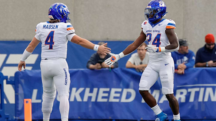 Boise State running back Dylan Riley (24) celebrates with quarterback Maddux Madsen. Boise State running back Dylan Riley (24) celebrates with quarterback Maddux Madsen.