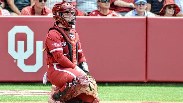 Oklahoma catcher Kendall Wells sits behind home plate between innings against Mississippi State in the Norman Super Regional. Oklahoma catcher Kendall Wells sits behind home plate between innings against Mississippi State in the Norman Super Regional.