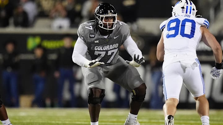 Sep 27, 2025; Boulder, Colorado, USA; Colorado Buffaloes offensive tackle Jordan Seaton (77) pass protects on Brigham Young Cougars defensive end Hunter Clegg (90) in the second quarter at Folsom Field. Mandatory Credit: Ron Chenoy-Imagn Images