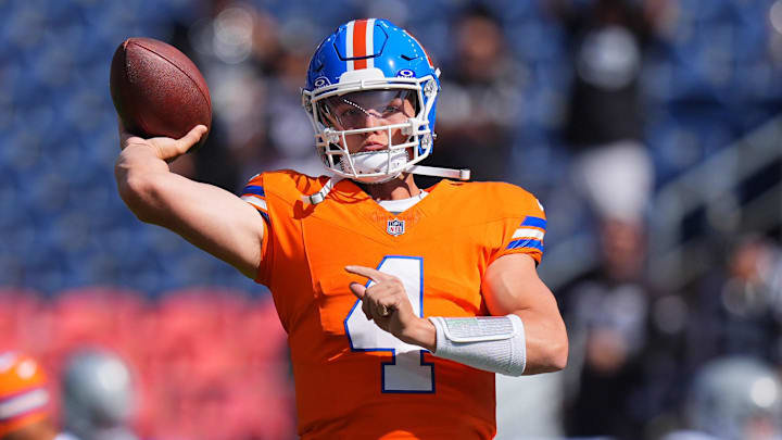 Oct 6, 2024; Denver, Colorado, USA; Denver Broncos quarterback Zach Wilson (4) warms up before the game against the Las Vegas Raiders at Empower Field at Mile High. Mandatory Credit: Ron Chenoy-Imagn Images