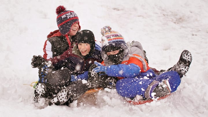 Kids sledding in the snow