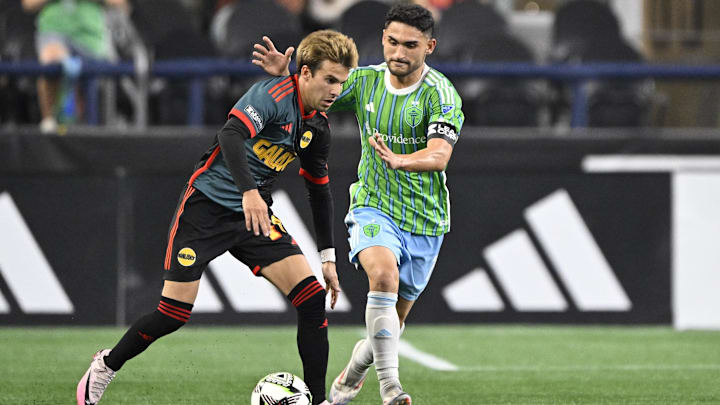 LA Galaxy midfielder Riqui Puig (10) controls the ball during the second half against Seattle Sounders FC midfielder Cristian Roldan (7) at Lumen Field