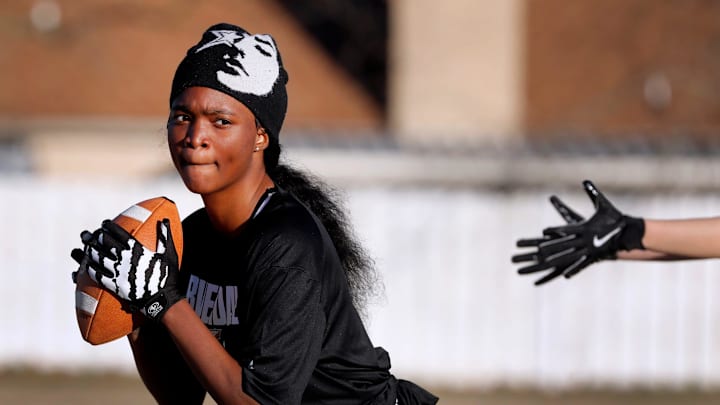 Jacquita Morris looks before passing the ball during the Riverdale girls’ flag football practice on Tuesday, Feb. 25, 2025, at Riverdale.