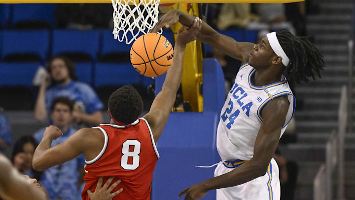 Feb 23, 2025; Los Angeles, California, USA; UCLA Bruins forward William Kyle III (24) blocks a shot by Ohio State Buckeyes guard Micah Parrish (8) during the second half at Pauley Pavilion presented by Wescom. Mandatory Credit: Robert Hanashiro-Imagn Images