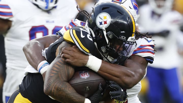 Aug 17, 2024; Pittsburgh, Pennsylvania, USA;  Pittsburgh Steelers running back Jalen Warren (30) carries the ball against Buffalo Bills linebacker Dorian Williams (42) during the second quarter at Acrisure Stadium. Mandatory Credit: Charles LeClaire-USA TODAY Sports