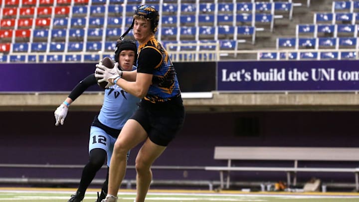 The Carroll Chargers’ Jaxx DeJean (9) turns to run after catching a pass during a 7-on-7 football tournament Saturday, April 13, 2024 at the UNI Dome in Cedar Falls, Iowa.