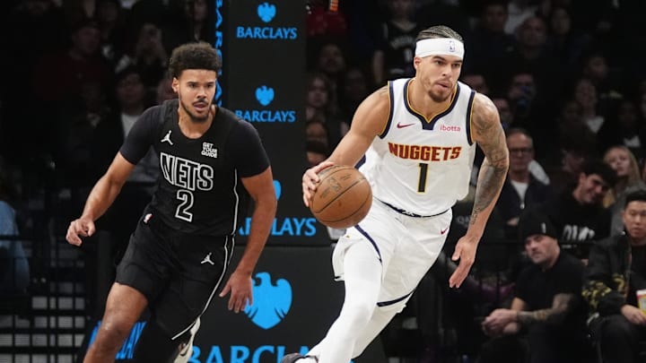 Oct 29, 2024; Brooklyn, New York, USA; Denver Nuggets small forward Michael Porter Jr. (1) dribbles the ball up the court past Brooklyn Nets small forward Cameron Johnson (2) during the first half at Barclays Center. Mandatory Credit: Gregory Fisher-Imagn Images