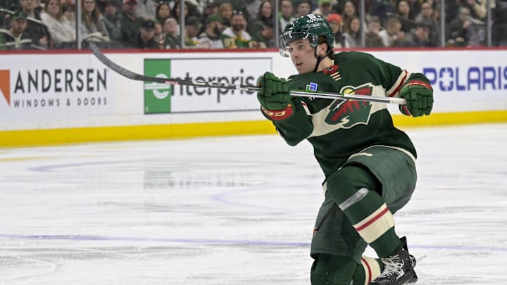 Mar 14, 2024; Saint Paul, Minnesota, USA; Minnesota Wild defenseman Brock Faber (7) takes a shot on goal against the Anaheim Ducks during the second period at Xcel Energy Center. Mandatory Credit: Nick Wosika-Imagn Images