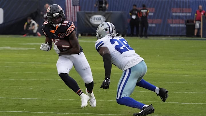 Sep 21, 2025; Chicago, Illinois, USA; Dallas Cowboys free safety Malik Hooker (28) tackles Chicago Bears wide receiver Luther Burden III (10) during the second half at Soldier Field. Mandatory Credit: David Banks-Imagn Images