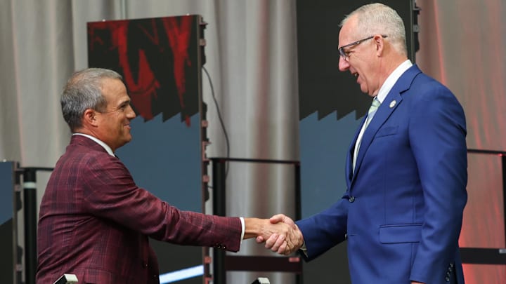 Jul 14, 2025; Atlanta, GA, USA; South Carolina Gamecocks head coach Shane Beamer and SEC commissioner Greg Sankey shake hands during SEC Media Day at Omni Atlanta Hotel. Mandatory Credit: Jordan Godfree-Imagn Images