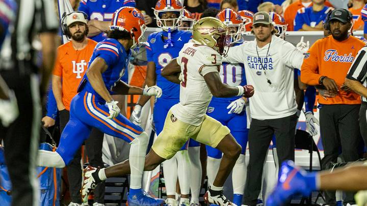 Nov 29, 2025; Gainesville, Florida, USA; Florida State Seminoles defensive back Edwin Joseph (3) runs back an interception during the second quarter against the Florida Gators at Ben Hill Griffin Stadium. Mandatory Credit: Bob Kupbens-Imagn Images Nov 29, 2025; Gainesville, Florida, USA; Florida State Seminoles defensive back Edwin Joseph (3) runs back an interception during the second quarter against the Florida Gators at Ben Hill Griffin Stadium. Mandatory Credit: Bob Kupbens-Imagn Images