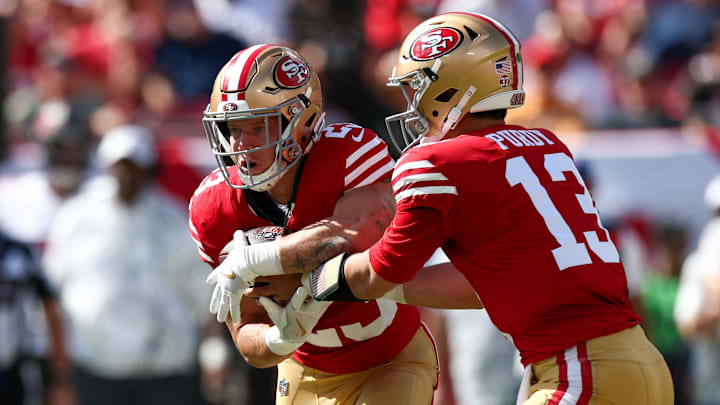 Nov 10, 2024; Tampa, Florida, USA; San Francisco 49ers quarterback Brock Purdy (13) hands off to running back Christian McCaffrey (23) against the Tampa Bay Buccaneers in the first quarter at Raymond James Stadium. Mandatory Credit: Nathan Ray Seebeck-Imagn Images
