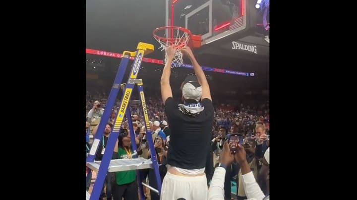 Florida center Rioux cuts down the nets after the national title