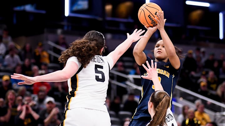 Mar 7, 2026; Indianapolis, IN, USA; Michigan Wolverines guard Mila Holloway (3) shoots over Iowa Hawkeyes center Ava Heiden (5) during the second half at Gainbridge Fieldhouse. Mandatory Credit: Robert Goddin-Imagn Images Mar 7, 2026; Indianapolis, IN, USA; Michigan Wolverines guard Mila Holloway (3) shoots over Iowa Hawkeyes center Ava Heiden (5) during the second half at Gainbridge Fieldhouse. Mandatory Credit: Robert Goddin-Imagn Images