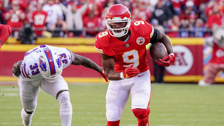 Oct 16, 2022; Kansas City, Missouri, USA; Kansas City Chiefs wide receiver JuJu Smith-Schuster (9) runs the ball as Buffalo Bills cornerback Siran Neal (33) chases during the game at GEHA Field at Arrowhead Stadium. Mandatory Credit: Denny Medley-Imagn Images