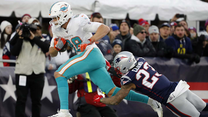Miami Dolphins tight end Mike Gesicki (88) scores the winning touchdown behind New England Patriots strong safety Patrick Chung (23) with less than a minute to go in the fourth quarter at Gillette Stadium in the 2019 season finale.