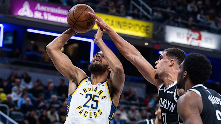 Nov 5, 2025; Indianapolis, Indiana, USA; Indiana Pacers forward Jeremiah Robinson-Earl (25) shoots the ball while Brooklyn Nets forward Michael Porter Jr. (17) defends in the first half  at Gainbridge Fieldhouse. Mandatory Credit: Trevor Ruszkowski-Imagn Images