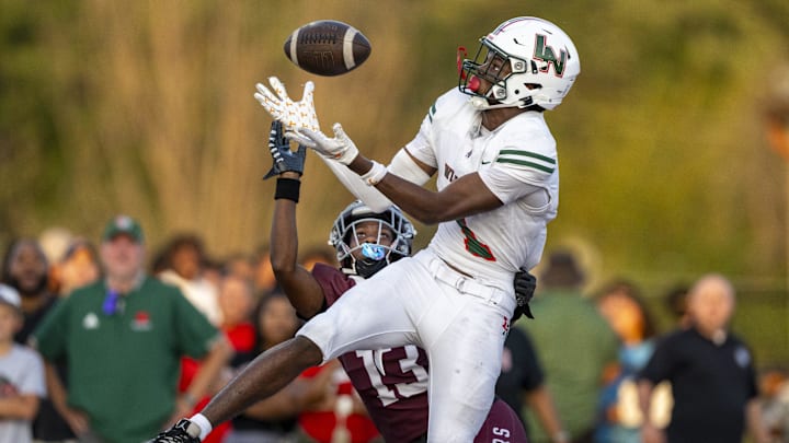Lawrence North High School sophomore Monshun Sales (1) makes a catch in the end zone to score while being defended by Lawrence Central High School junior DJ Summers (13) during the first half of an IHSAA varsity football game, Friday, Aug. 23, 2024, at Lawrence Central High School.