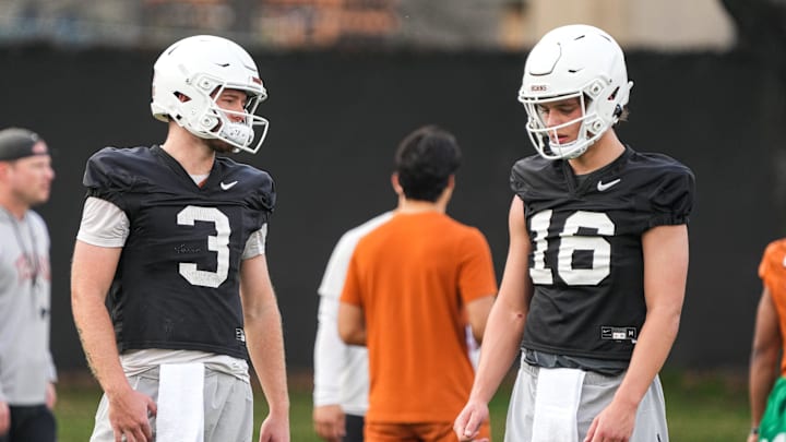 Texas quarterbacks Arch Manning (16) and Quinn Ewers talk during the team's first spring practice of 2023 at the Frank Denius Fields.