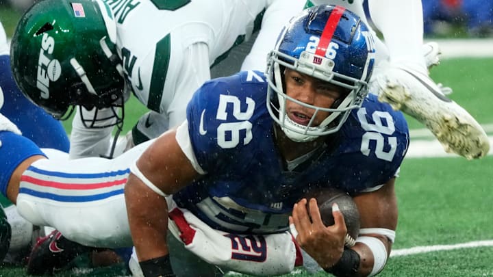 New York Giants running back Saquon Barkley (26) is shown with the ball against the Jets. The