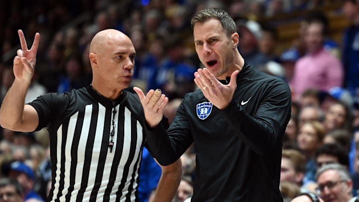 Feb 14, 2026; Durham, North Carolina, USA; Duke Blue Devils head coach Jon Scheyer (right) argues with an official during the first half against the Clemson Tigers at Cameron Indoor Stadium.