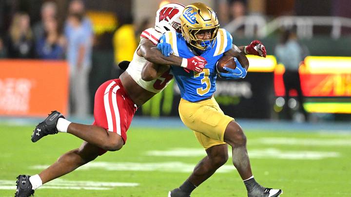 UCLA Bruins running back Wayne Knight (3) runs for a first down before he is stopped by Wisconsin Badgers cornerback Bryce West. UCLA Bruins running back Wayne Knight (3) runs for a first down before he is stopped by Wisconsin Badgers cornerback Bryce West.