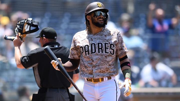 Jun 6, 2021; San Diego, California, USA; San Diego Padres shortstop Fernando Tatis Jr. (right) reacts after striking out to end the first inning against the New York Mets as umpire Tripp Gibson (left) looks on at Petco Park. Mandatory Credit: Orlando Ramirez-Imagn Images