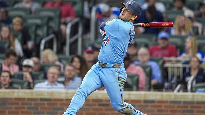 Blue Jays center fielder Daulton Varsho (5) hits a sacrifice fly ball to drive in a run against the Atlanta Braves during the sixth inning Blue Jays center fielder Daulton Varsho (5) hits a sacrifice fly ball to drive in a run against the Atlanta Braves during the sixth inning