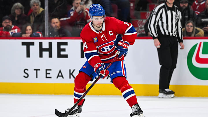 Montreal Canadiens center Nick Suzuki (14) plays the puck against the Colorado Avalanche in shootout at Bell Centre. Montreal Canadiens center Nick Suzuki (14) plays the puck against the Colorado Avalanche in shootout at Bell Centre.