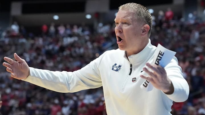 Mar 22, 2026; San Diego, CA, USA; Utah State Aggies head coach Jerrod Calhoun reacts in the first half against the Arizona Wildcats during a second round game of the men's 2026 NCAA Tournament at Viejas Arena. 