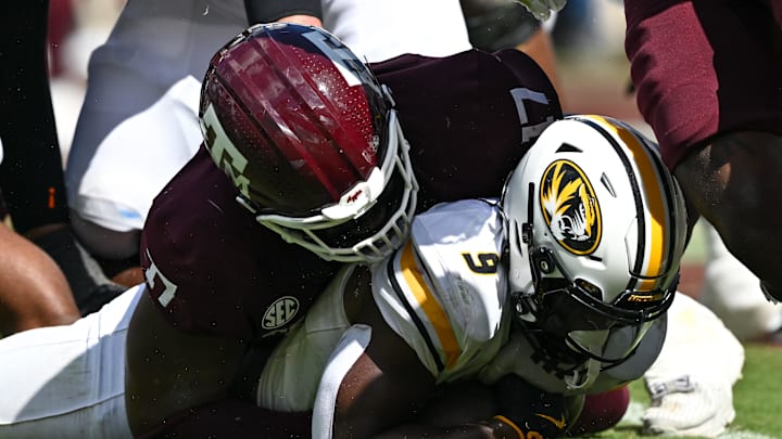 Oct 5, 2024; College Station, Texas, USA; Texas A&M Aggies defensive lineman Albert Regis (17) stops Missouri Tigers running back Marcus Carroll (9) in the fourth quarter at Kyle Field. Mandatory Credit: Maria Lysaker-Imagn Images. 
