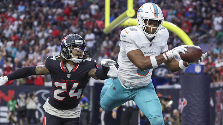 Dec 15, 2024; Houston, Texas, USA; Miami Dolphins tight end Jonnu Smith (9) makes a reception for a touchdown as Houston Texans cornerback Derek Stingley Jr. (24) defends during the third quarter at NRG Stadium. Mandatory Credit: Troy Taormina-Imagn Images