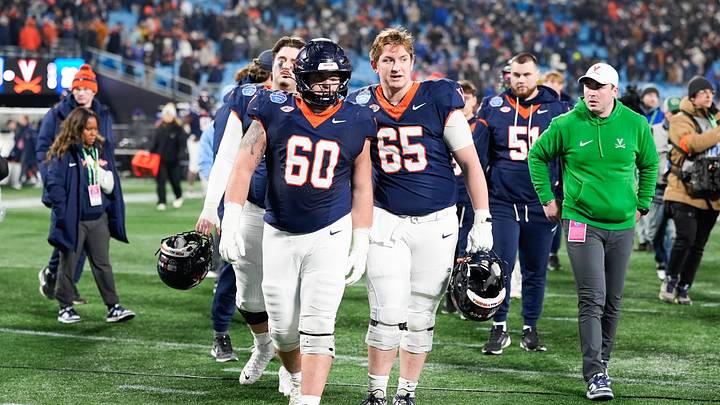 Dec 6, 2025; Charlotte, NC, USA; Virginia Cavaliers offensive lineman Drake Metcalf (60) and offensive lineman Grant Ellinger (65) walk off the field after the game against the Duke Blue Devils during the 2025 ACC Championship game at Bank of America Stadium. Mandatory Credit: Jim Dedmon-Imagn Images