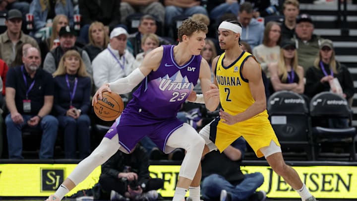 Feb 3, 2025; Salt Lake City, Utah, USA;  Utah Jazz forward Lauri Markkanen (23) protects the ball from Indiana Pacers guard Andrew Nembhard (2) during the second quarter at Delta Center. Mandatory Credit: Chris Nicoll-Imagn Images