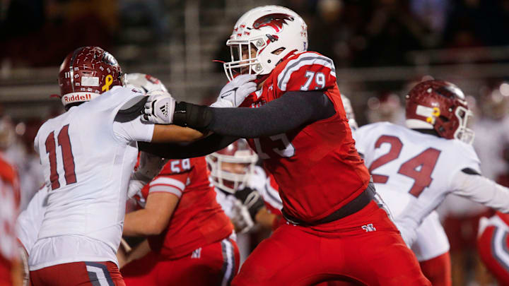 Nixa Eagles Jackson Cantwell holds back a Joplin defender during the championship game of Class 6 District 5 football at Nixa on Friday, Nov. 11, 2023.