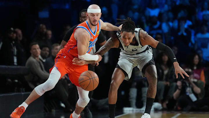 Dec 13, 2025; Las Vegas, Nevada, USA; Oklahoma City Thunder guard Alex Caruso (9) and San Antonio Spurs guard Devin Vassell (24) battle for the lose ball during the fourth quarter at T-Mobile Arena. Mandatory Credit: Kirby Lee-Imagn Images Dec 13, 2025; Las Vegas, Nevada, USA; Oklahoma City Thunder guard Alex Caruso (9) and San Antonio Spurs guard Devin Vassell (24) battle for the lose ball during the fourth quarter at T-Mobile Arena. Mandatory Credit: Kirby Lee-Imagn Images