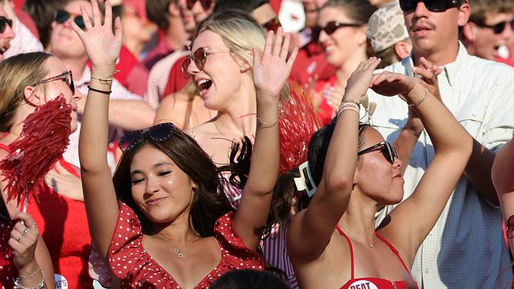 Oklahoma Sooners fans cheer during the second half against the Texas Longhorns at the Cotton Bowl.
