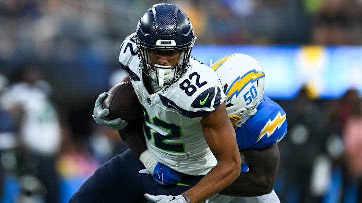 Aug 10, 2024; Inglewood, California, USA; Seattle Seahawks wide receiver Cody White (82) runs the ball against Los Angeles Chargers linebacker Shane Lee (50) during the fourth quarter at SoFi Stadium. Mandatory Credit: Jonathan Hui-Imagn Images