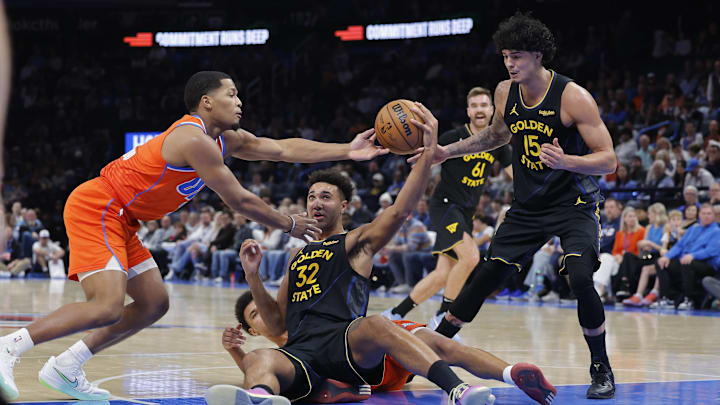 Nov 11, 2025; Oklahoma City, Oklahoma, USA; Golden State Warriors forward Trayce Jackson-Davis (32) and Oklahoma City Thunder guard Chris Youngblood (3) reach for a loose ball during the second half at Paycom Center. Mandatory Credit: Alonzo Adams-Imagn Images