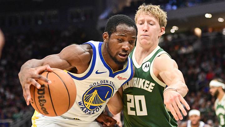 Oct 30, 2025; Milwaukee, Wisconsin, USA;  Golden State Warriors forward Jonathan Kuminga (1) drives for the basket again not Milwaukee Bucks guard AJ Green (20) in the second quarter at Fiserv Forum. Mandatory Credit: Benny Sieu-Imagn Images