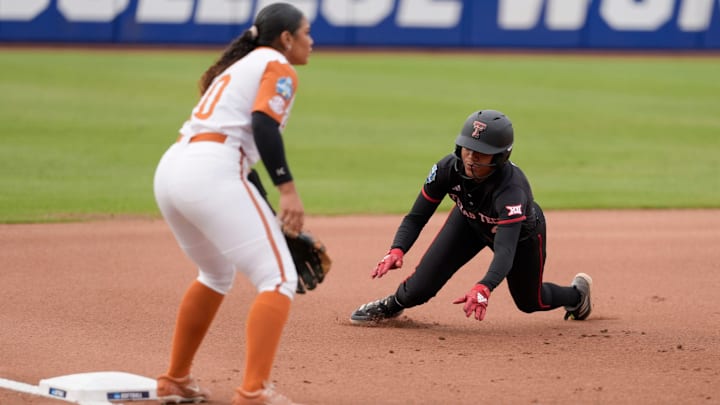 Texas Tech outfielder Mihyia Davis (42) slides to third beside Texas utility Mia Scott (10) in the first inning of Game 1 of the Women's College World Series championship series between the Texas Longhorns at Texas Tech Red Raiders at Devon Park in Oklahoma City, Wednesday, June 4, 2025. Texas won 2-1.