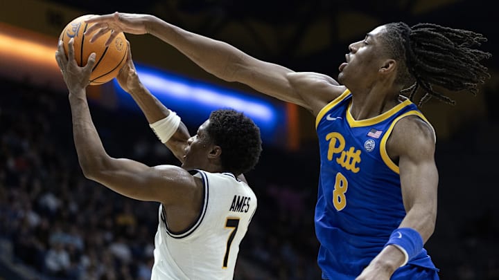 Feb 28, 2026; Berkeley, California, USA; California Golden Bears guard Dai Dai Ames (7) escapes a block attempt by Pittsburgh Panthers guard Omari Witherspoon (8) during the second half at Haas Pavilion. Mandatory Credit: D. Ross Cameron-Imagn Images