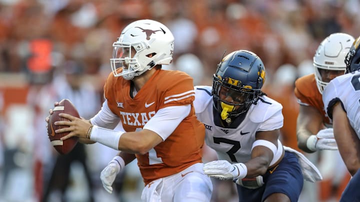 Oct 1, 2022; Austin, Texas, USA; West Virginia Mountaineers linebacker Jasir Cox (7) sacks Texas Longhorns quarterback Hudson Card (1) during the first quarter at Darrell K Royal-Texas Memorial Stadium. Mandatory Credit: Ben Queen-Imagn Images