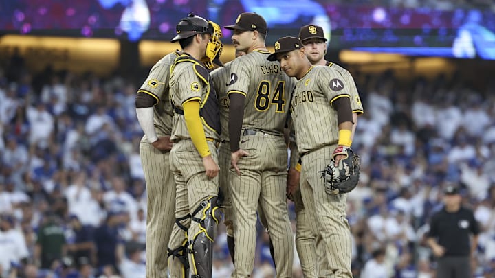 Oct 5, 2024; Los Angeles, California, USA; San Diego Padres pitcher Dylan Cease (84) huddles with the team in the second inning against the Los Angeles Dodgers during game one of the NLDS for the 2024 MLB Playoffs at Dodger Stadium. Mandatory Credit: Kiyoshi Mio-Imagn Images
