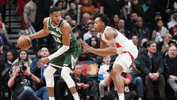 Jan 6, 2025; Toronto, Ontario, CAN; Milwaukee Bucks forward Giannis Antetokounmpo (34) controls the ball as Toronto Raptors forward Scottie Barnes (4) defends during the third quarter at Scotiabank Arena. Mandatory Credit: Nick Turchiaro-Imagn Images