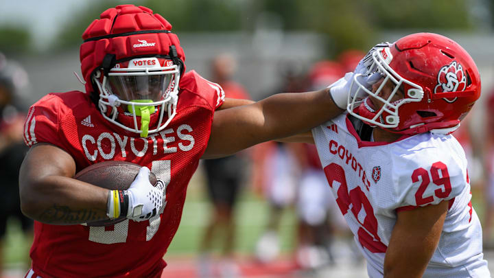 USD’s running back L.J. Phillips Jr. (24) pushes defense back Roman Tillman (29) on Monday, Aug. 5, 2024, at Dakota Dome practice field in Vermillion. USD’s running back L.J. Phillips Jr. (24) pushes defense back Roman Tillman (29) on Monday, Aug. 5, 2024, at Dakota Dome practice field in Vermillion.